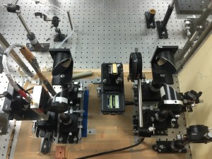 Part of the experimental setup. The tiny gold rectangle in the middle is the parallel plate waveguide. On the left is the detector, and on the right is the emitter. - Daniel Gilmore
