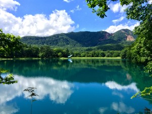 Reflections: A near perfect mirror image captured in the volcanic lake’s turquoise water. ~ Haihao Liu